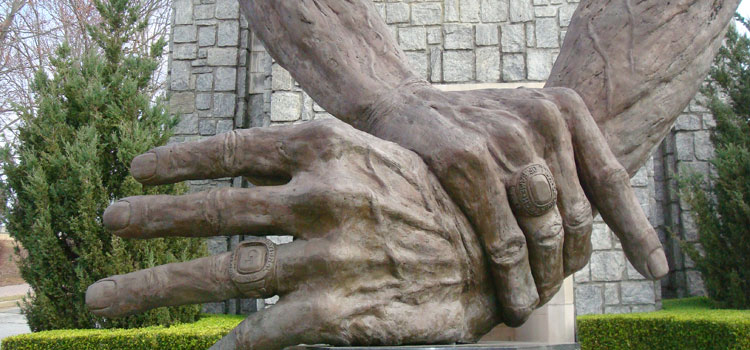 Statue of chiropractic hands in position to adjust a back
